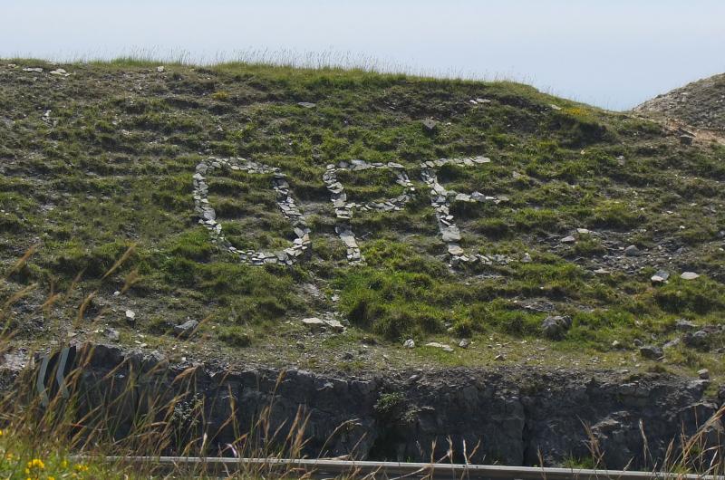Image of pebbles on a hill spelling out the words opes