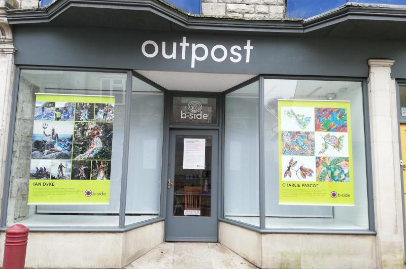 A photograph of the outside of the b-side project space on Portland exhibitiing large colourful posters created by Portland residents