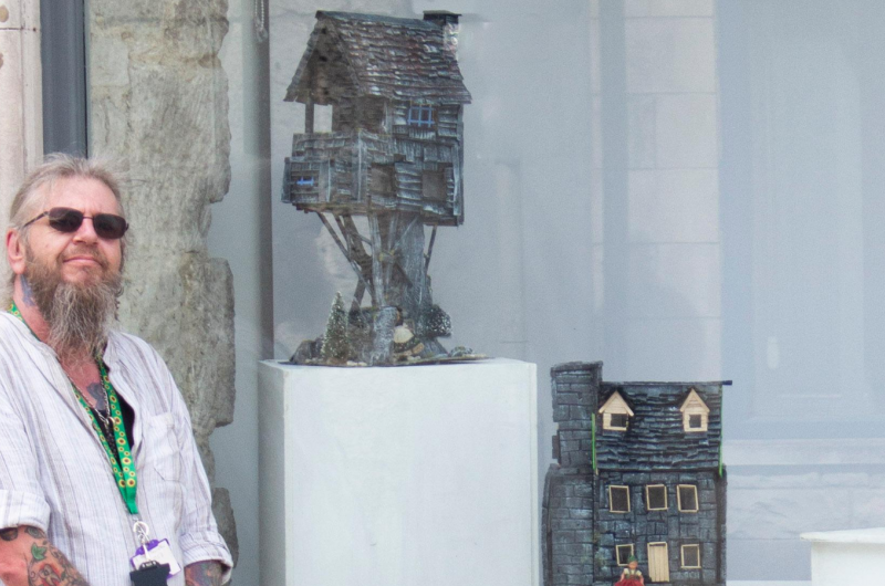 A man standing next to a window