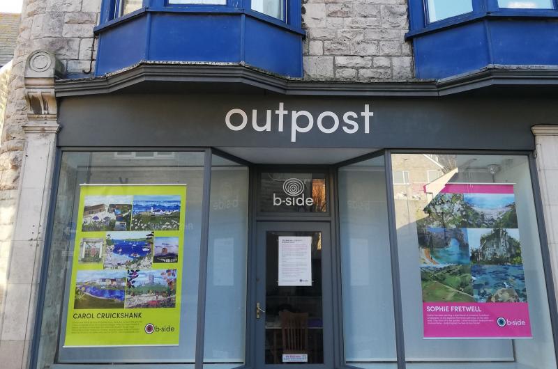 A photograph of the outside of the b-side project space on Portland exhibitiing large colourful posters created by Portland residents