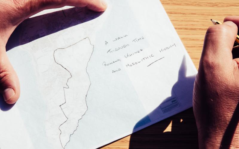 A piece of paper with a traced map and some writing