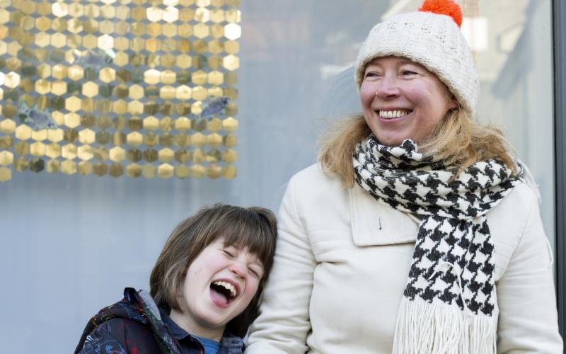 Close up of a woman and child the child is laughing