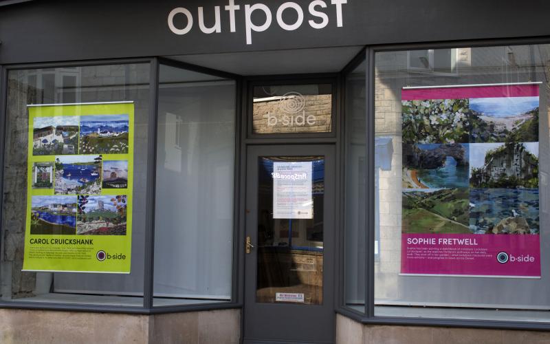 Outpost project space with two posters in the windows