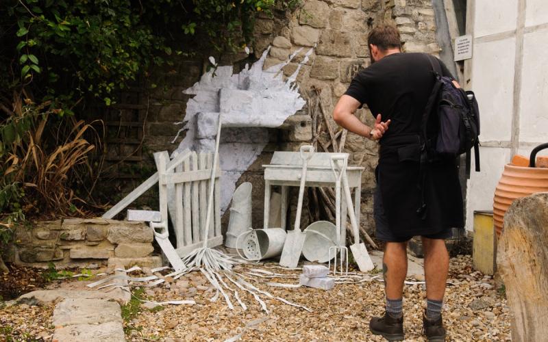 Man looking at a sculpture